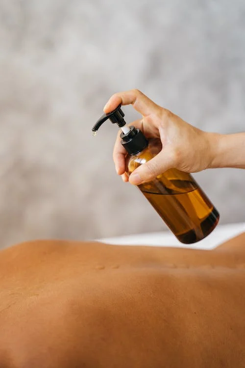 An image of a person pouring oil during a massage