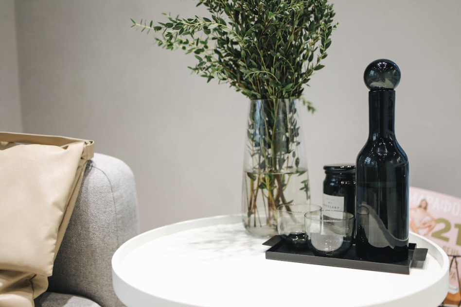 An image of a vase and bottles on a table