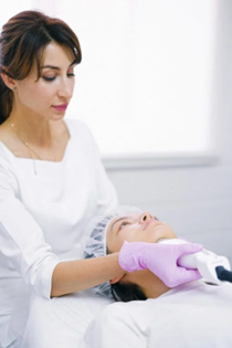 An image of a professional female performing laser treatment for hair removal on a client