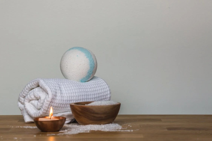 An image of a candle and a towel on a table