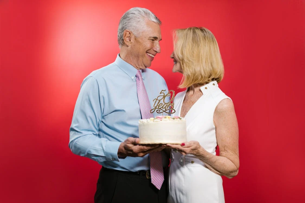 two people holding a cake