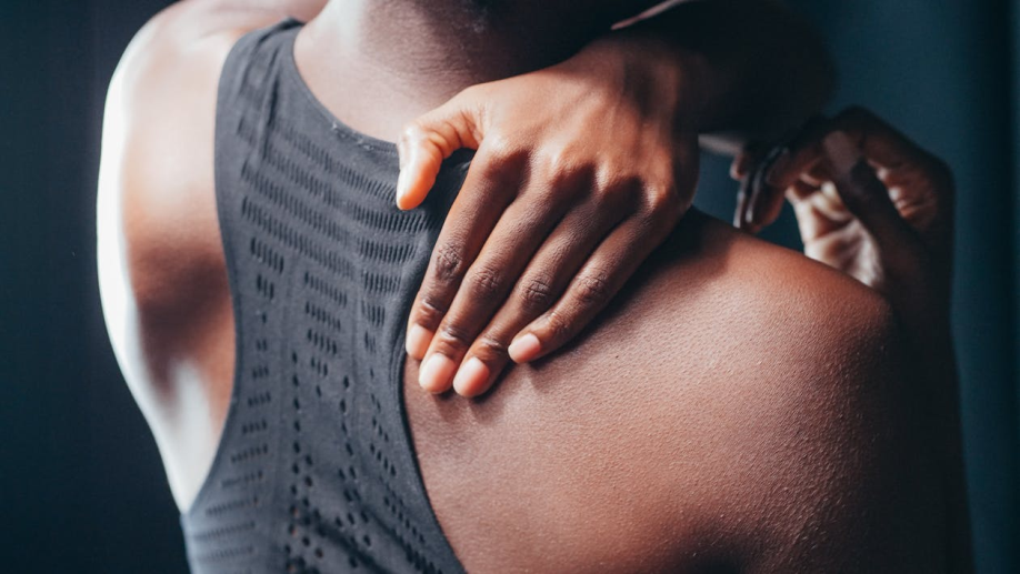 An image of a woman touching her back