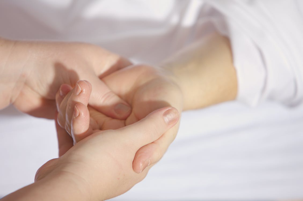 A person getting a hand massage for chronic pain