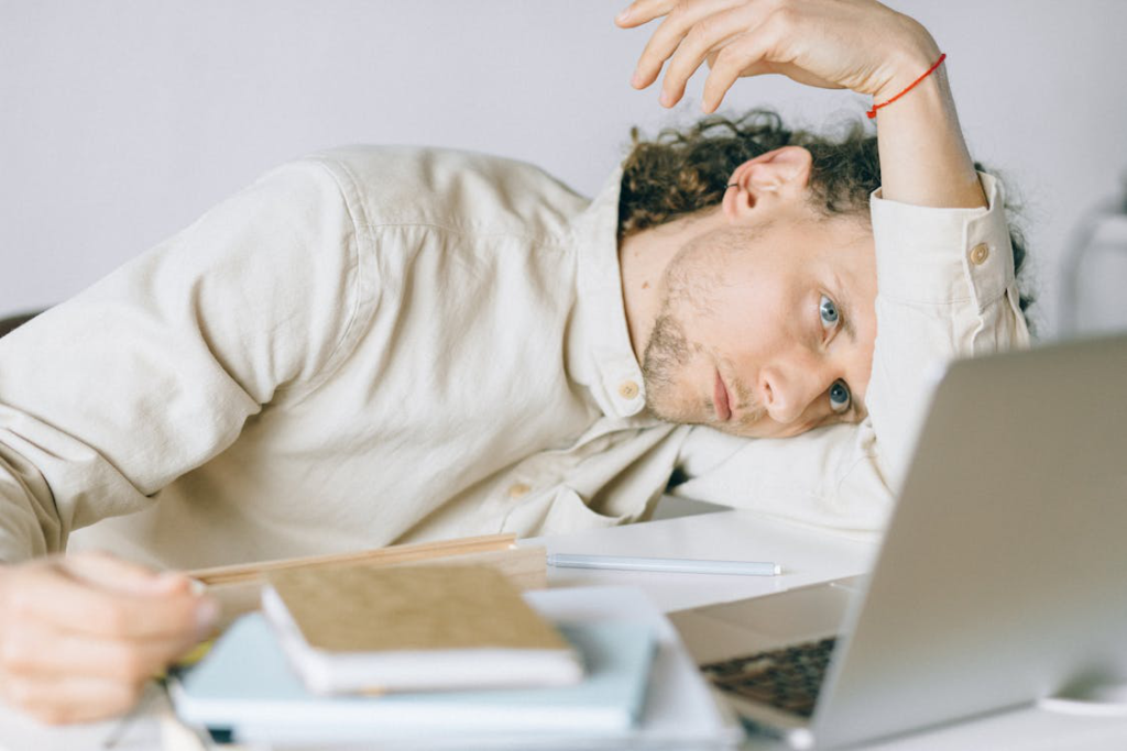An image of a person sitting in front of a laptop