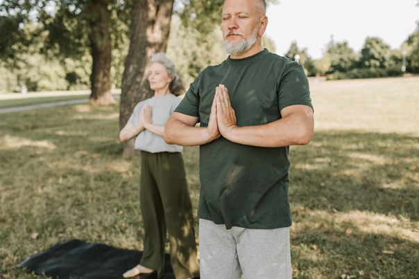 two elderly people meditating