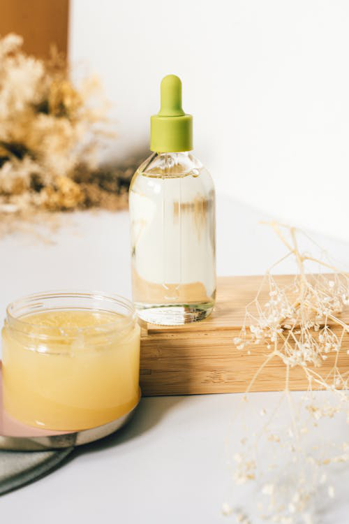 An image of an oil bottle on a wooden tray