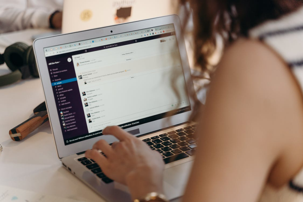 An image of a person typing on a laptop