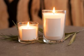 two lighted candles on a table