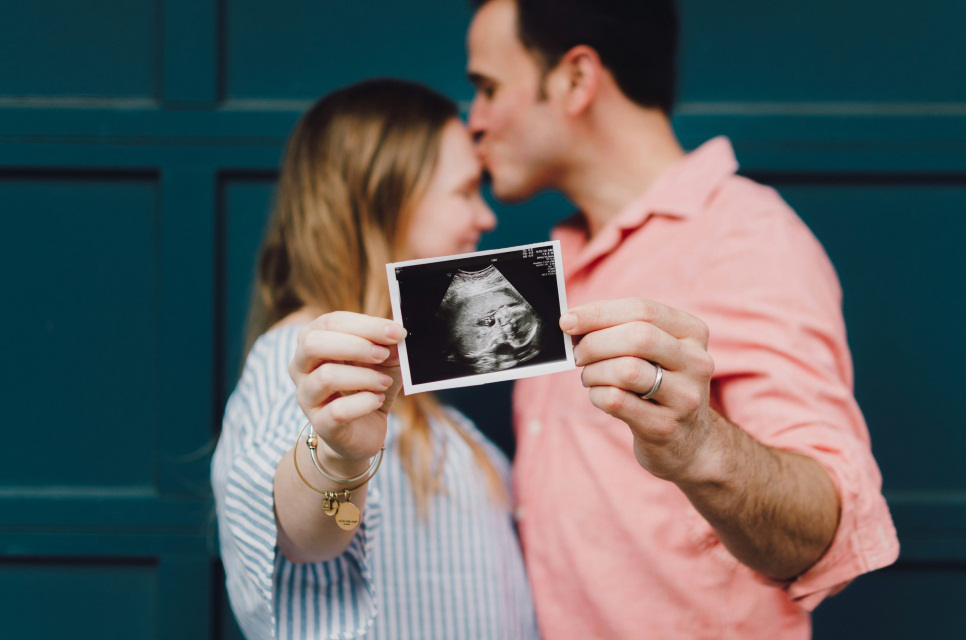 An image of a couple holding a photo
