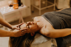 a person massaging a woman’s head