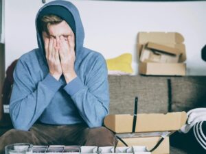 a person in stress hiding their face under their hands