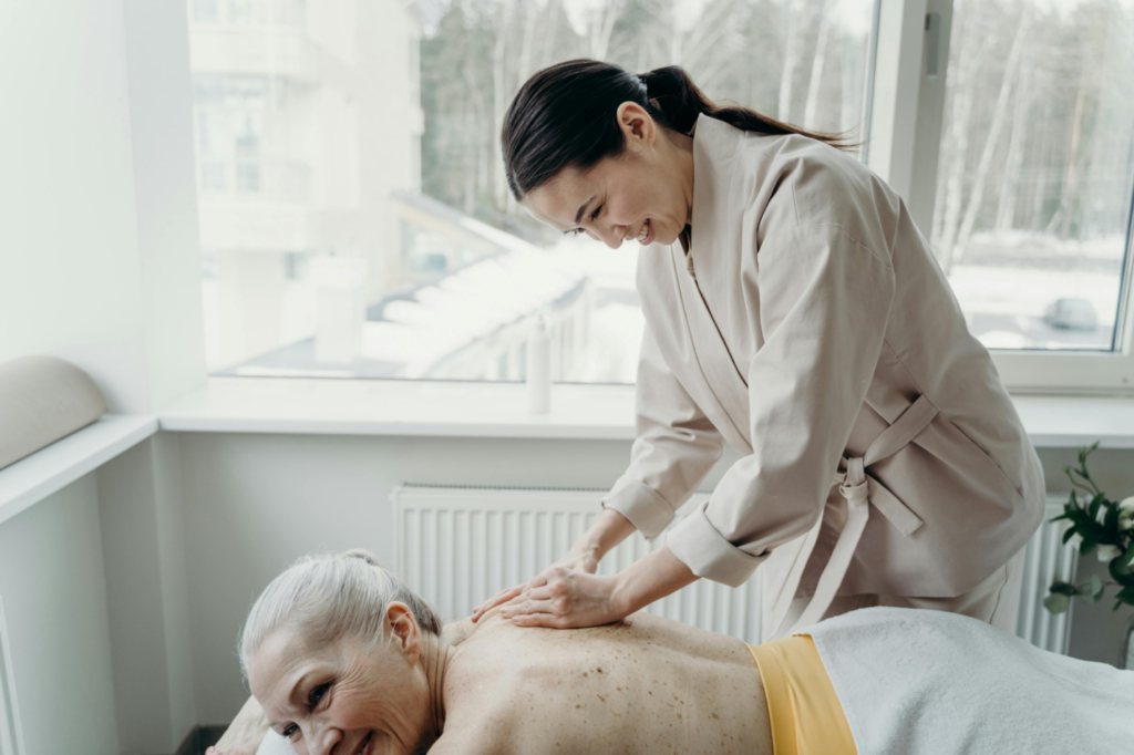 woman giving another woman a back massage