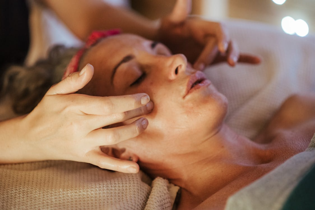 close-up of a woman's face getting a lymphatic massage done on her face