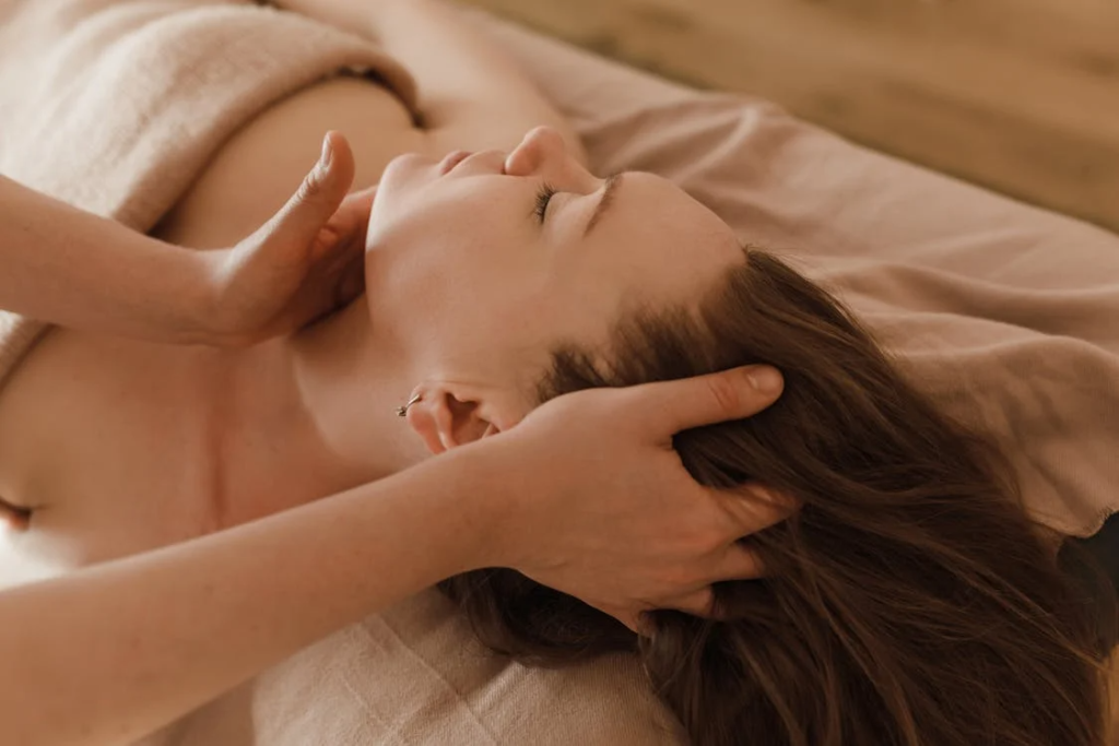 a woman getting a head and neck massage from a massage therapist