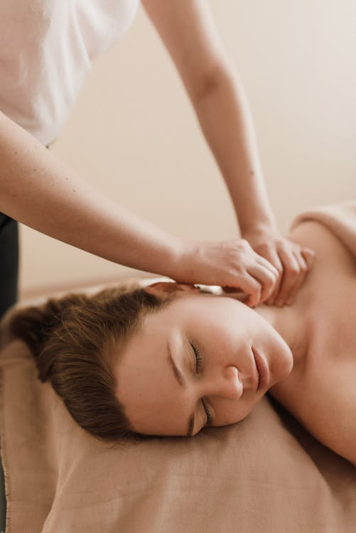 a woman receiving a neck massage