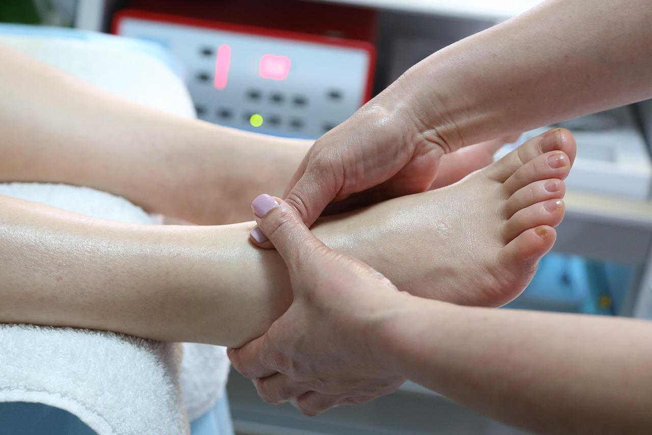 Therapist applying gentle pressure during a professional foot massage session.