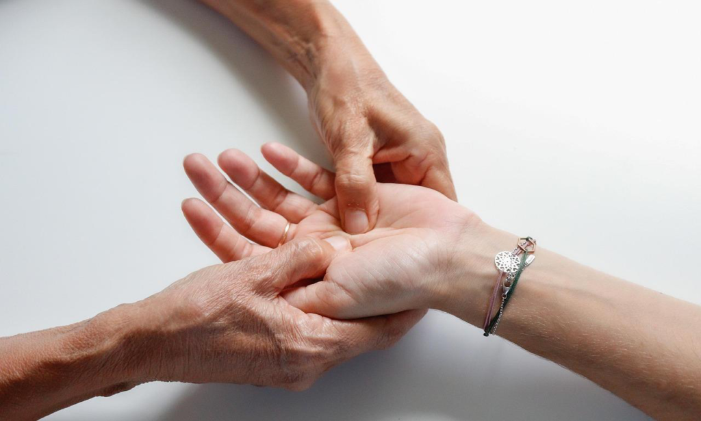 Close-up of a therapist giving a relaxing hand massage.