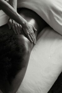 Therapist performing a relaxing back massage to release muscle tension and improve circulation.