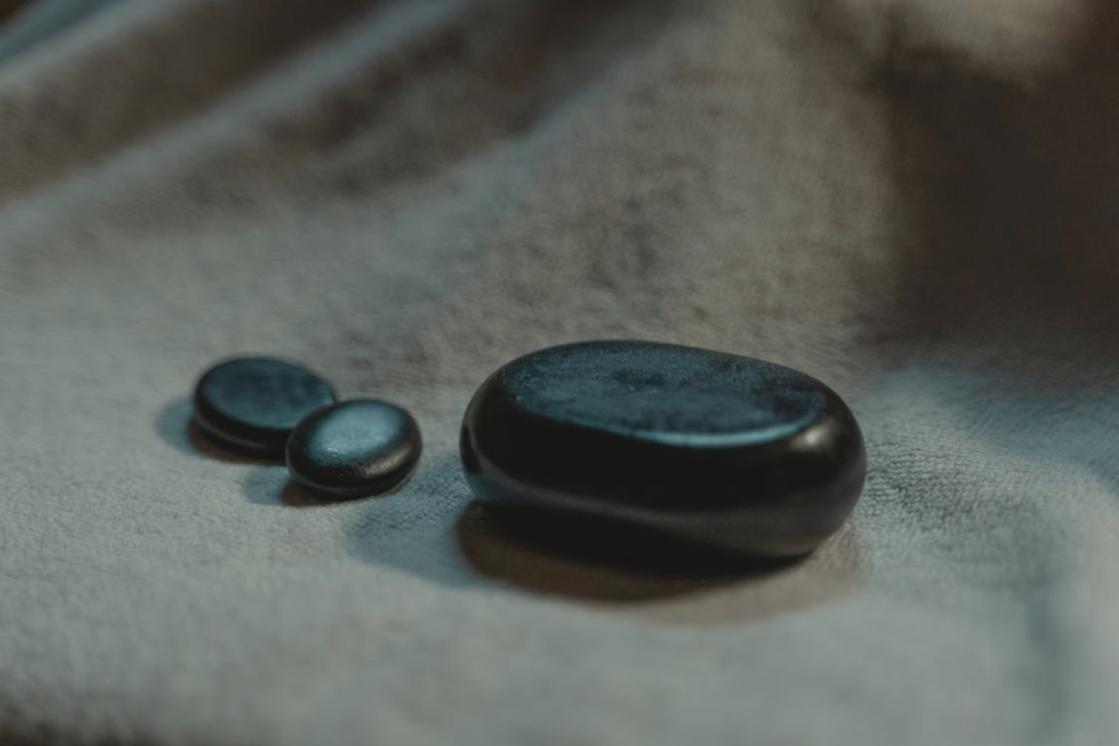 Heated stones arranged on a massage table