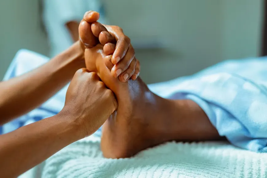 a person getting their feet massaged