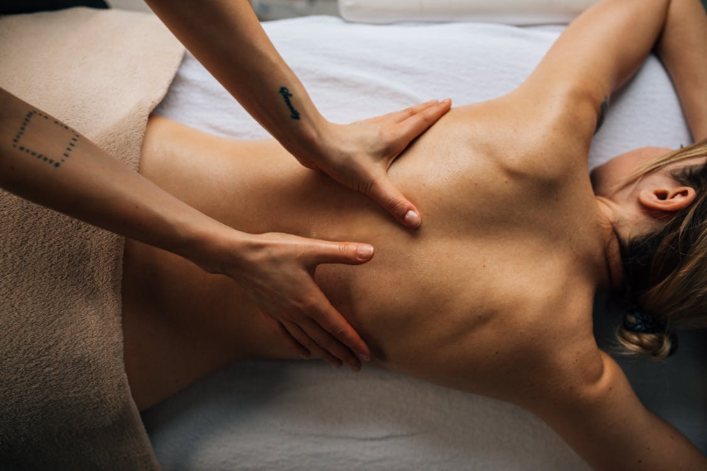Client receiving deep, targeted pressure along the back to relieve stiffness and muscular tightness during a deep tissue massage in Edmonton.