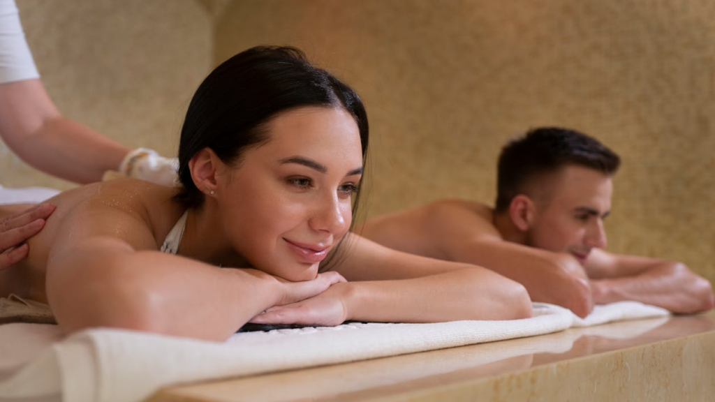 Couple enjoying a relaxing side-by-side massage session, experiencing calm and connection together during a couples massage in Edmonton.