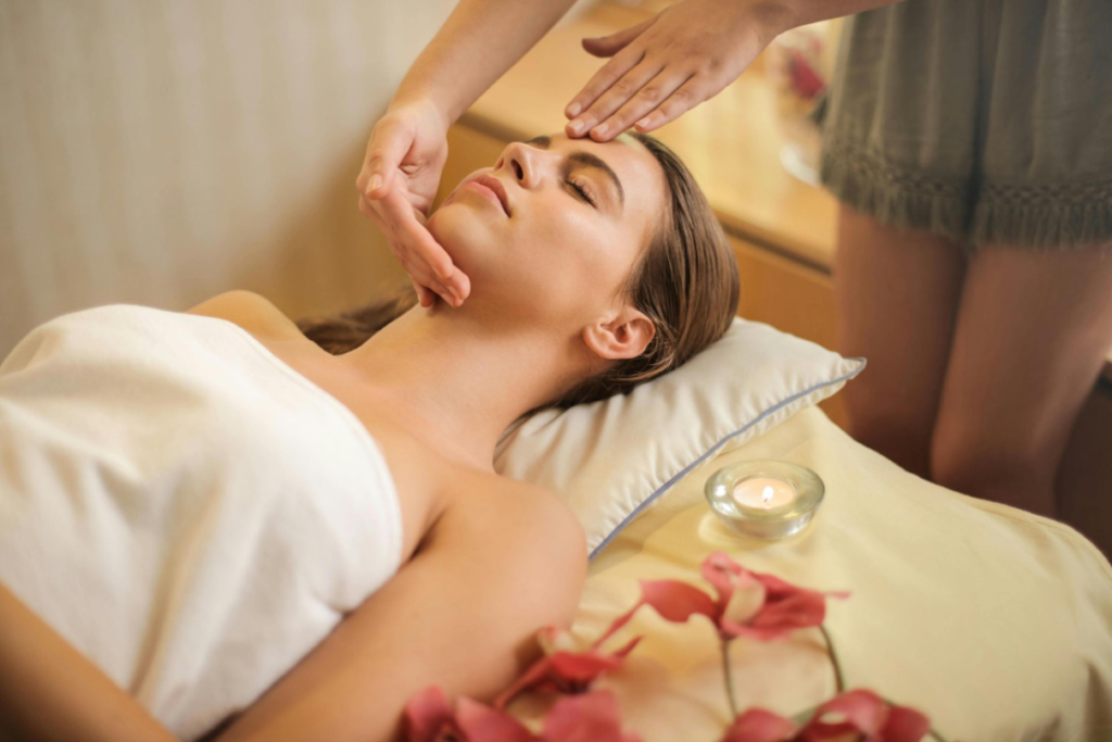 Woman receiving relaxing hot stone spa treatment with heated stones
