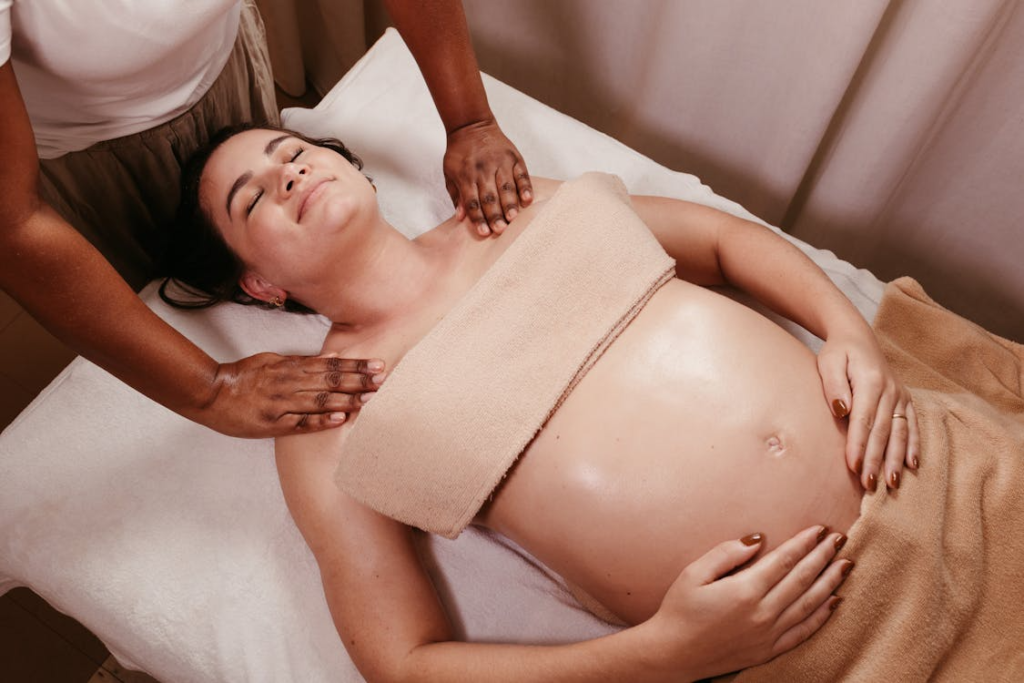 Pregnant woman receiving a relaxing prenatal massage in a spa setting