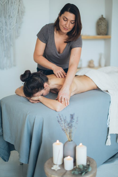 An image of a woman getting a massage at a spa