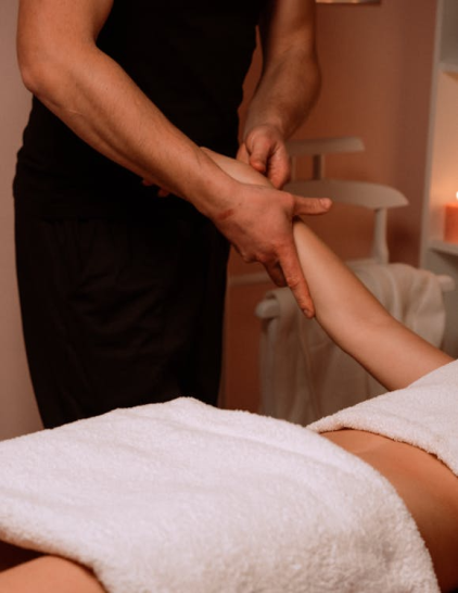 An image of a massage therapist massaging a woman's arm