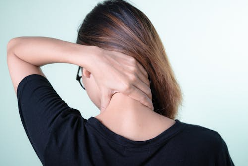 An image a woman with her hand on her neck
