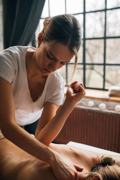 An image of a masseuse using her elbows to press pressure points