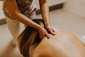 An image of a woman getting a neck and shoulder massage