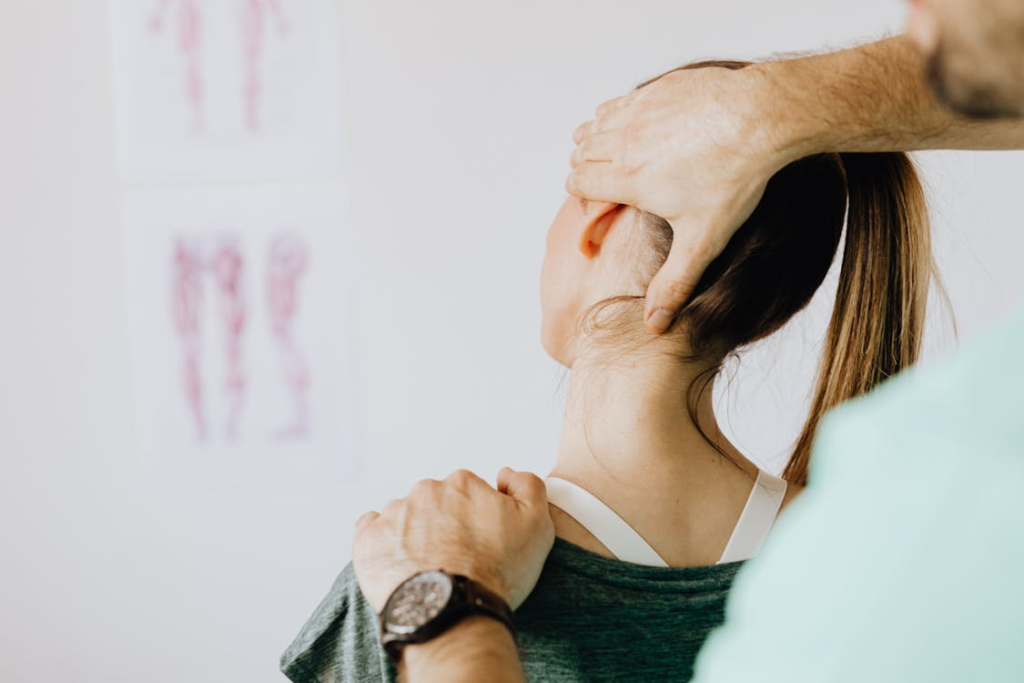a therapist working on a client’s shoulder after physical strain