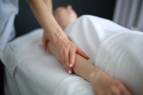 An image of a woman getiing a hand massage