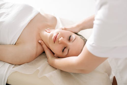An image woman getting a neck massage