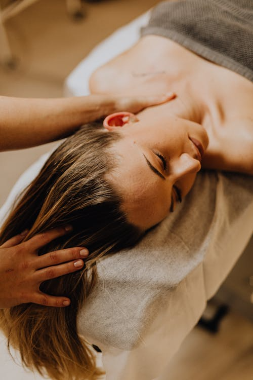 a woman getting a head and neck massage 