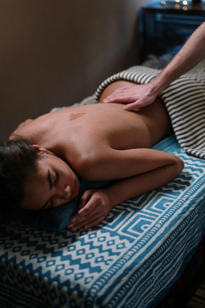 a girl lying on her stomach on a massage table