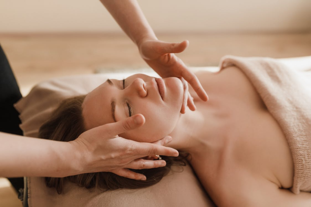 close-up of a woman getting a lymphatic drainage massage to reduce facial swelling