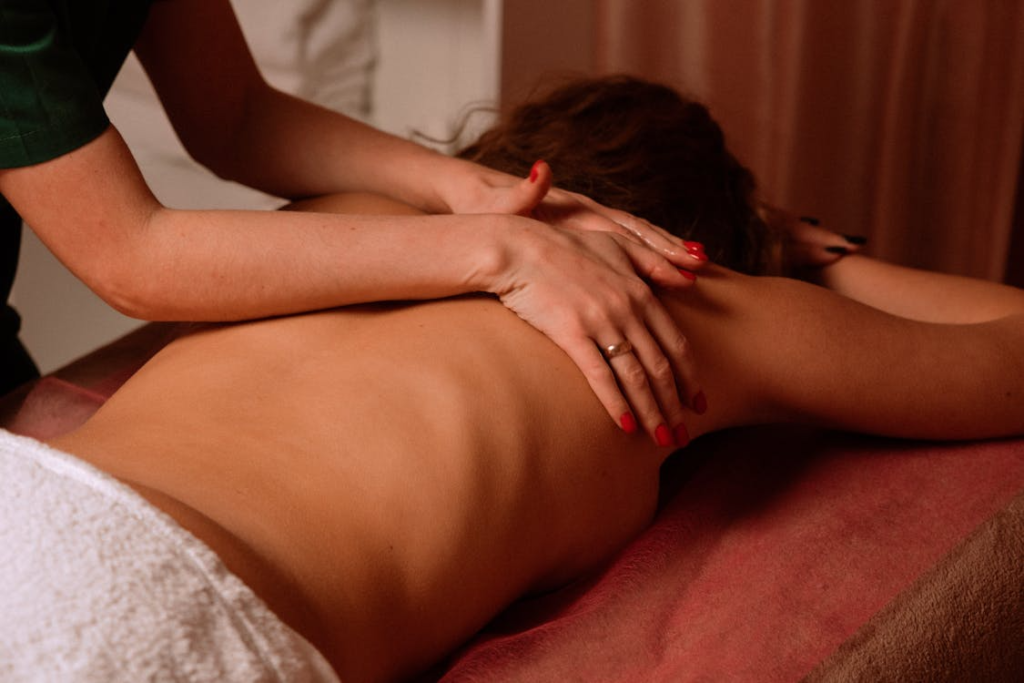  a masseur giving a woman a back massage