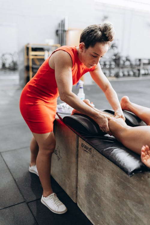 a masseur giving an athlete a massage after a workout