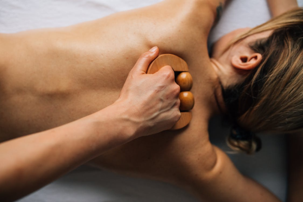 a woman getting a massage with a wooden tool