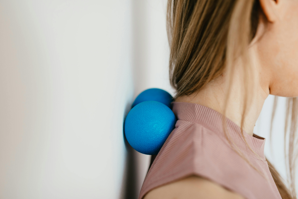 close-up of a woman using massage balls on her neck