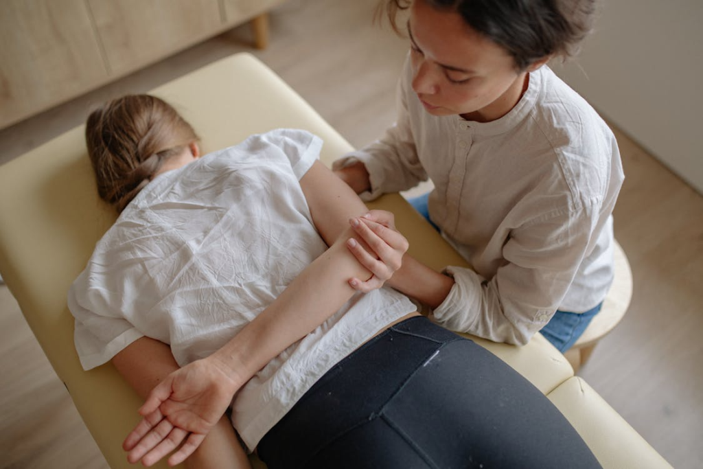 a woman lying upside down on a table getting a sports massage