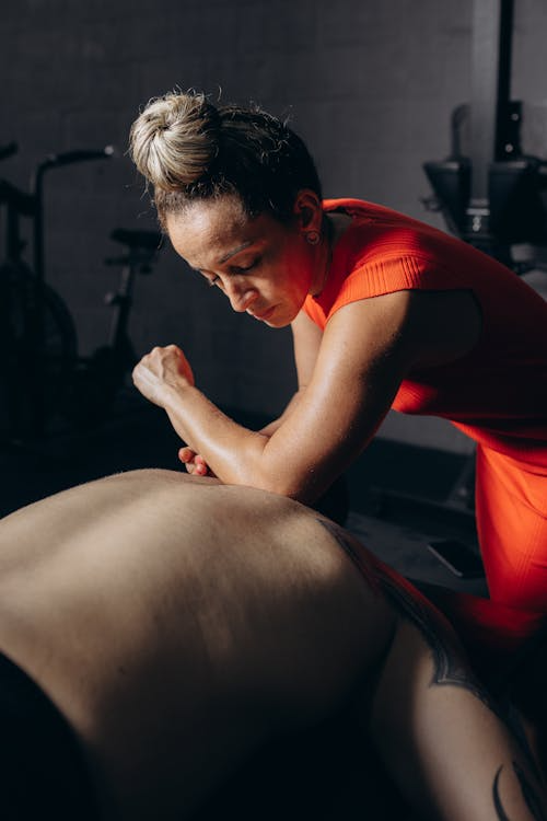 a woman giving an athlete a massage