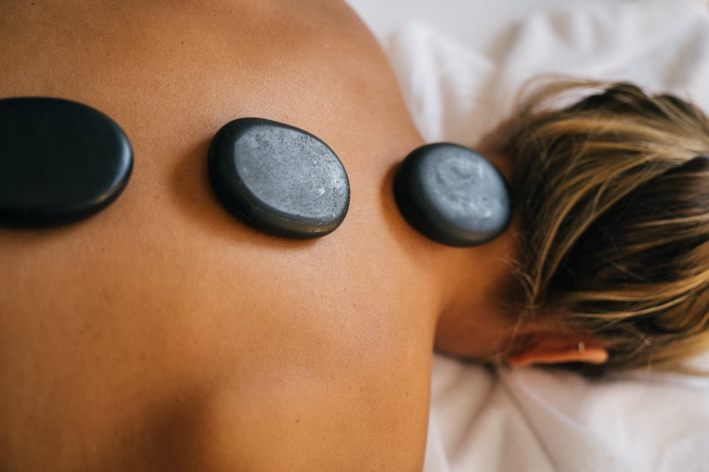 This photo shows some hot stones on a person’s back.