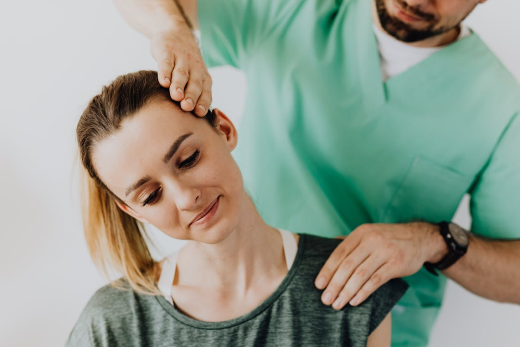 a professional massage therapist helping a woman with a neck massage