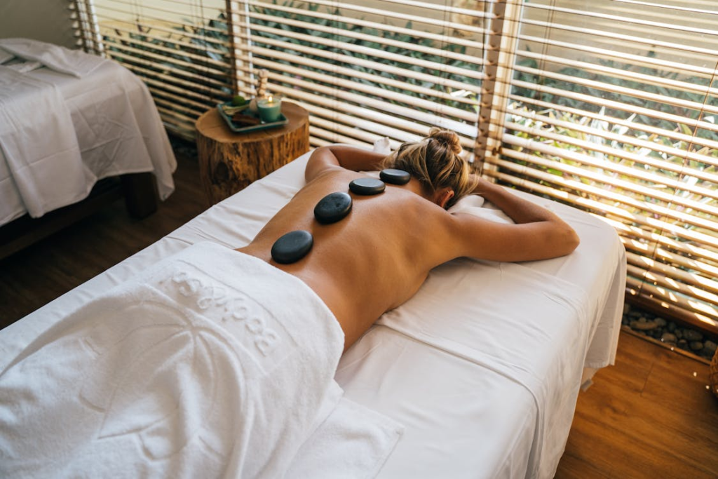 This photo shows a woman with hot stones on her back.