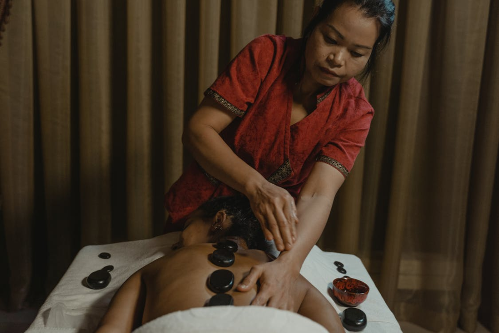 This photo shows a woman massaging another person.