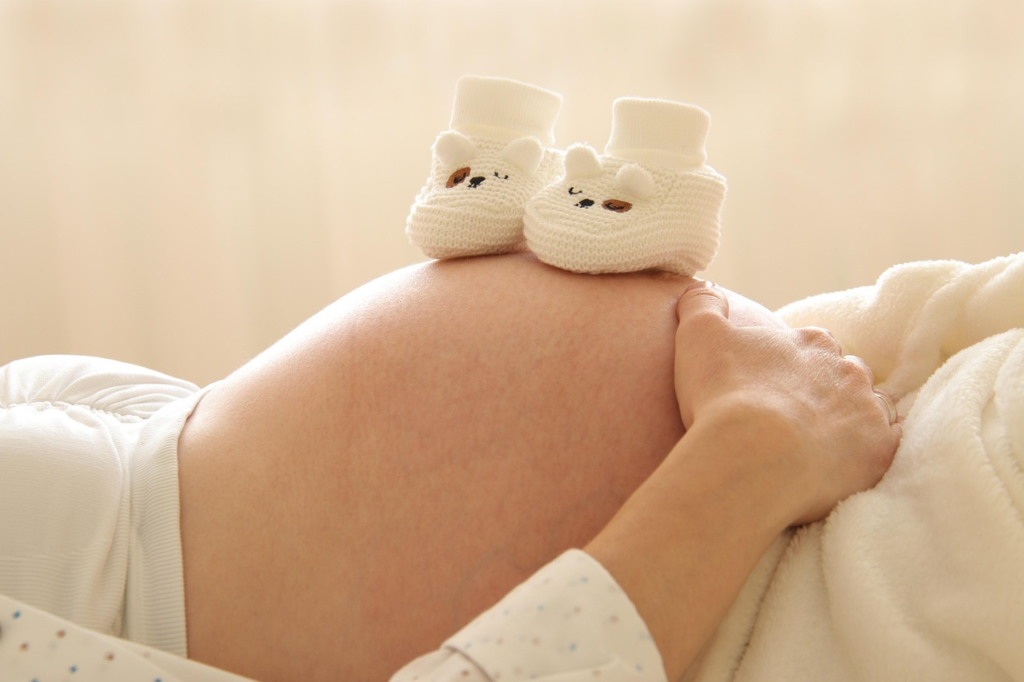 a pregnant woman lying down for a pregnancy massage